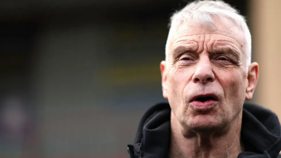 Brian Noble watches on intently as Bradford are in action, with his face screwed up in concentration.