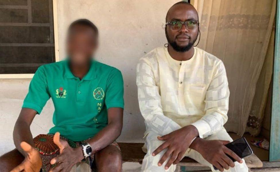 Jude (left) sitting down wearing a green T-shirt with his face blurred and Dooyum Dominic Ingye (right) in a cream outfit