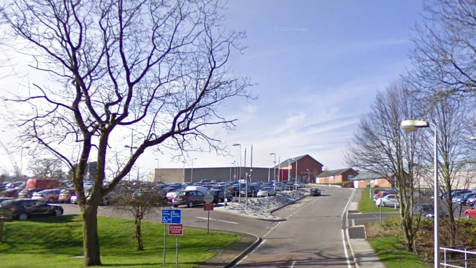 HMP Lowdham Grange is pictured with cars parked in a car park