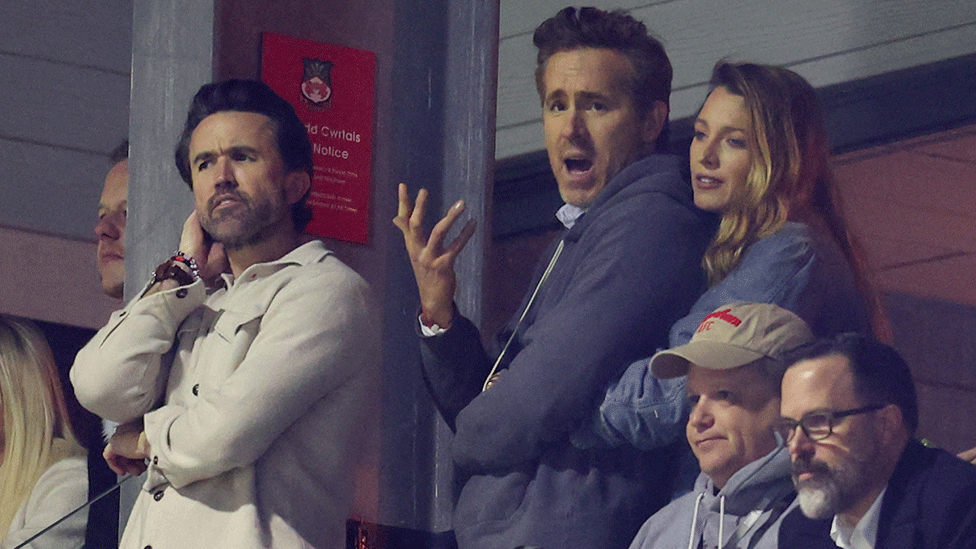 Pained expressions on the faces of Rob Mac, Ryan Reynolds and Blake Lively as they watch Wrexham lose to Chelsea in a cup match last month