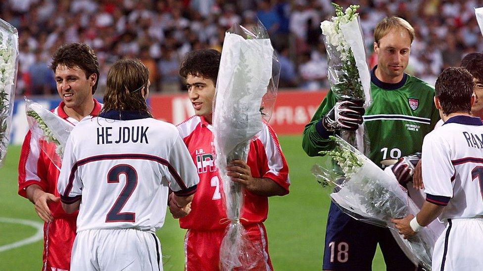 Iranian and US players with flowers