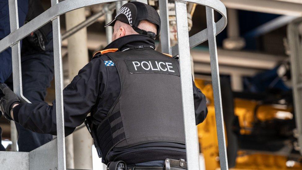 An officer dealing with the protesters