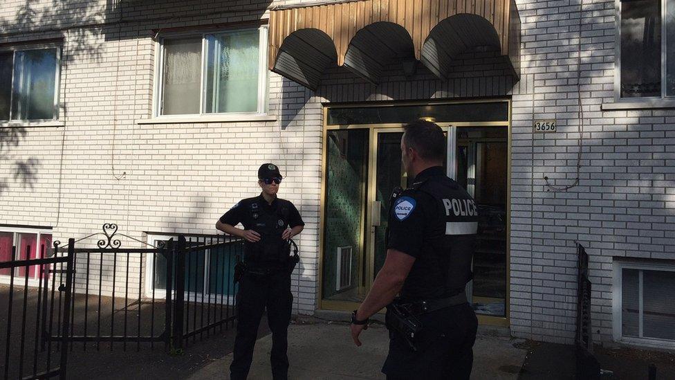 Montreal Police guard the front of the four storey building in Montreal on June 21, 2017, where Amor Ftouhi, who is suspected of stabbing a Michigan airport police officer, lived before traveling to the US earlier this month.