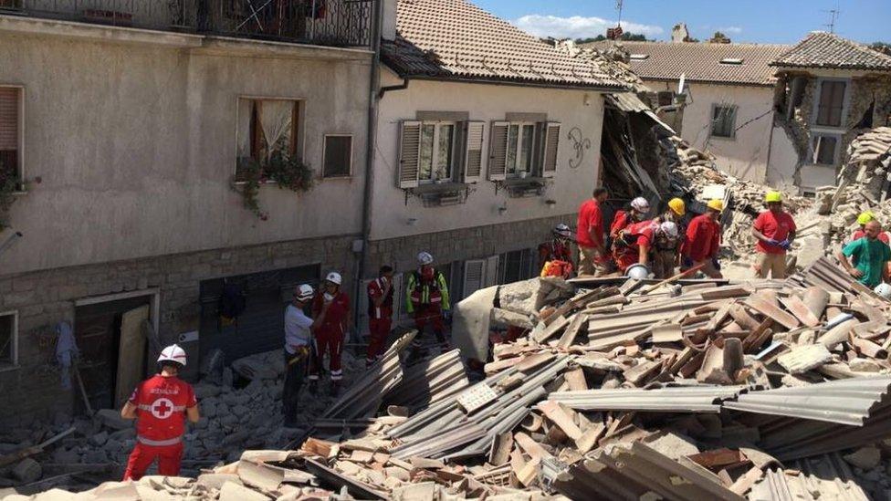 Rescuers look through rubble