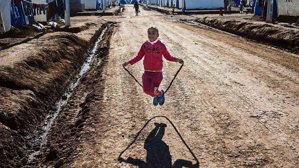 A displaced Iraqi girl, who fled the ongoing figthing between Islamic State (IS) group jihadists and government forces around Mosul, jumps rope at the Khazer refugee camp near the Kurdish checkpoint of Aski kalak, 40 km West of Arbil, the capital of the autonomous Kurdish region of northern Iraq, on January 6, 2017.