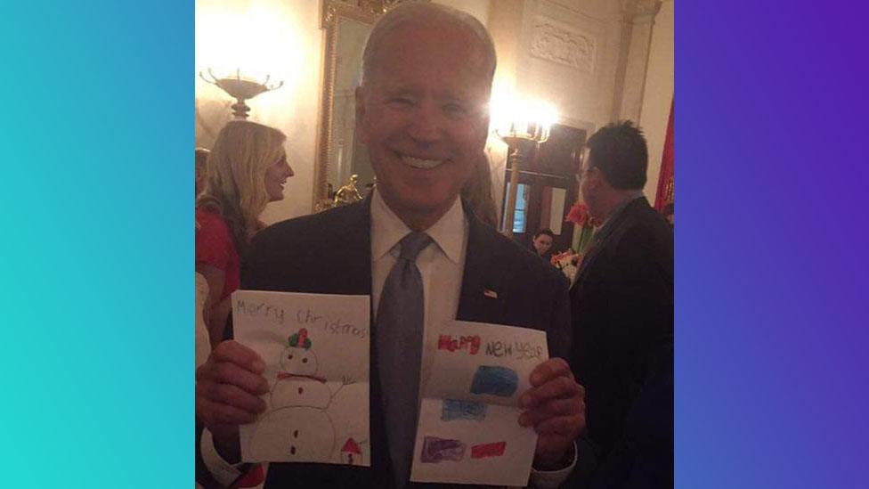 Joe Biden holding cards drawn by family