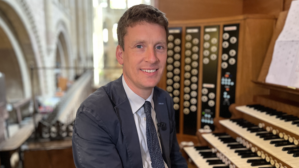 Ashley Grote in front of the organ