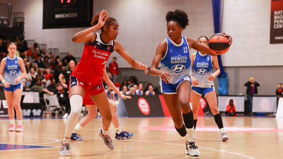 Christabel Osaboro taking on her opponent, wearing her Ipswich Basketball Club jersey