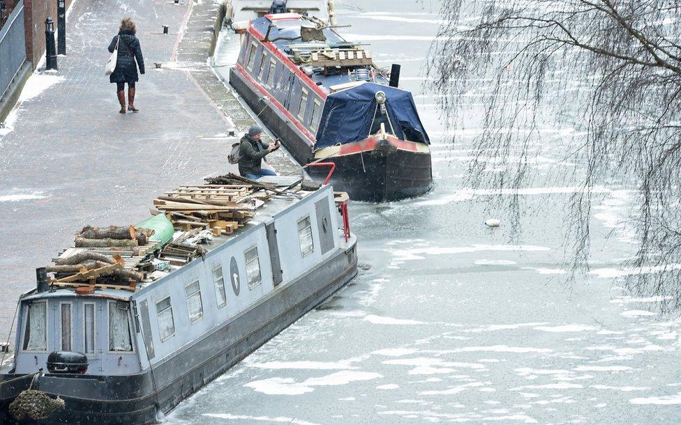 Moored canal boats on a frozen canal in Birmingham