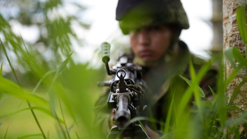 A Colombian soldier trains in Tumaco municipality, Narino department, Colombia on April 14, 2018 as they wait to take part in a military operation against renegade Colombian rebels who kidnapped and killed two Ecuadorean journalists and their driver.