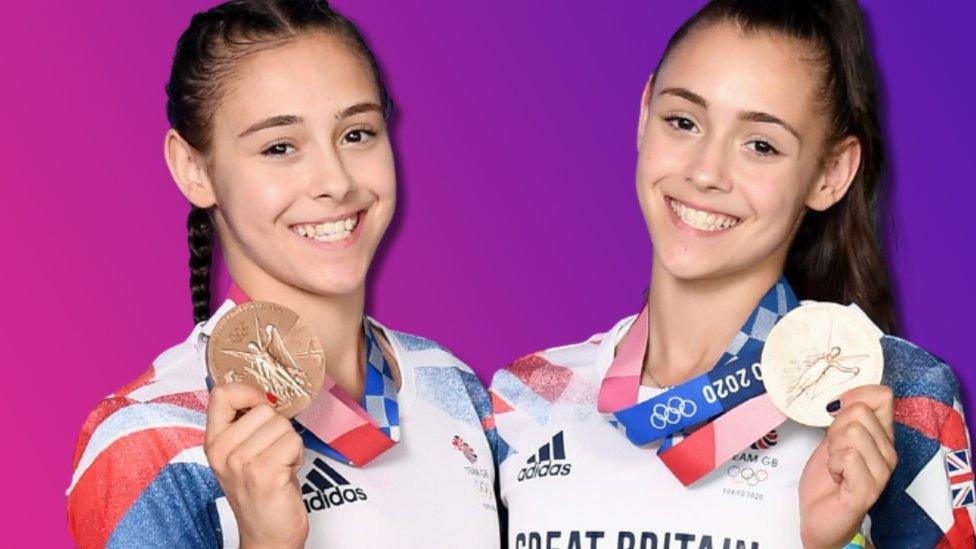 Gadirova twins smiling holding their olympic medals from the 2020 Tokyo Olympic Games