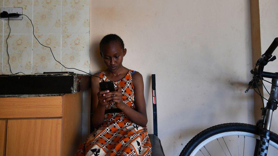 A Kenyan girl using a smartphone