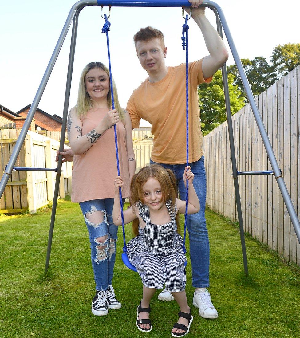 Violet on a swing with her mum Shelbie and dad Gareth