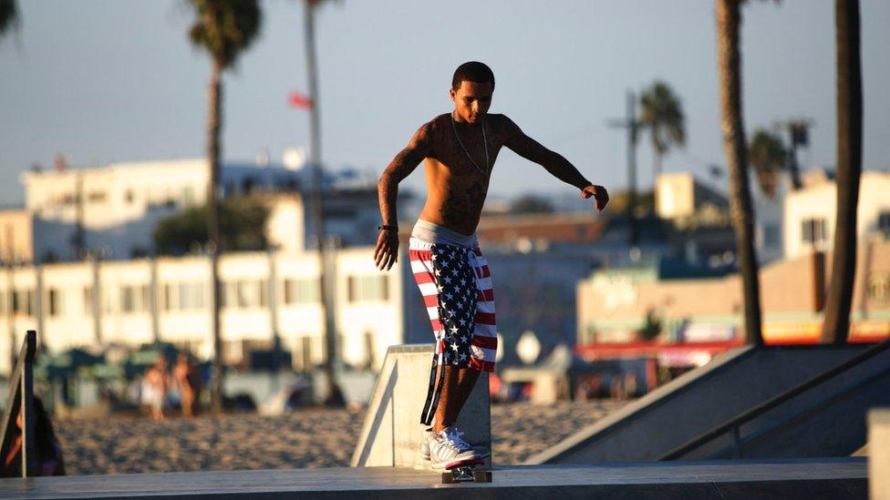 A man skateboarding in Venice beach CA on September 15, 2014.