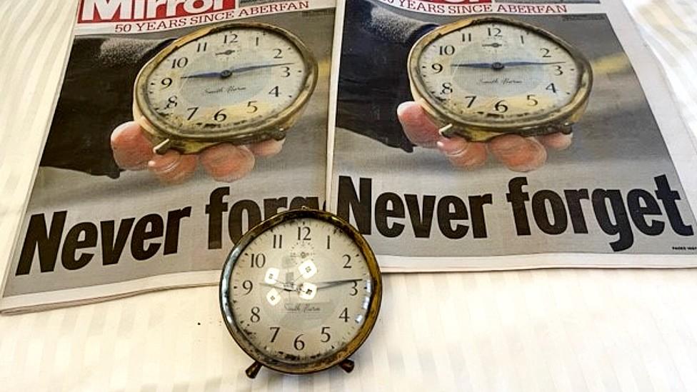 Clock and newspaper photos of it