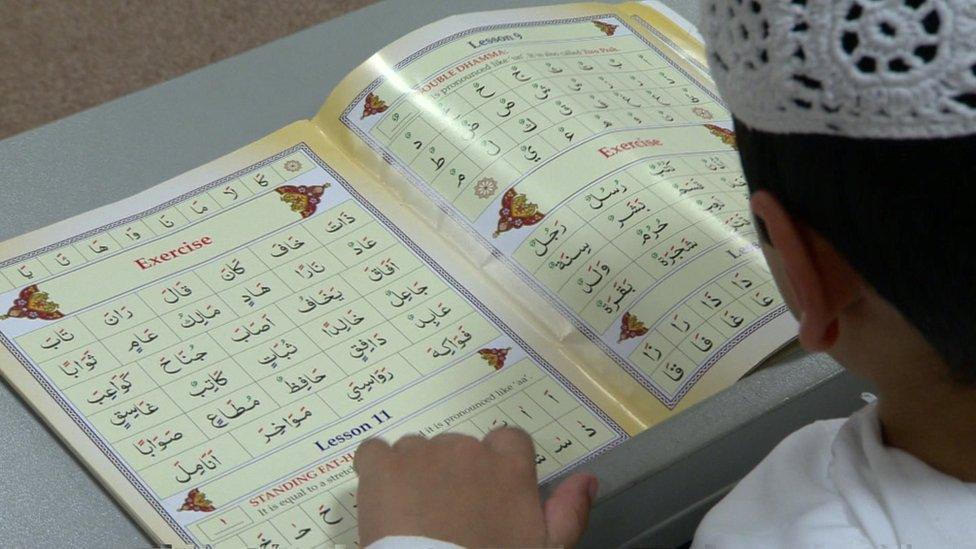 Boy with Arabic primer