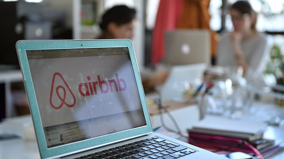 The Airbnb logo on a computer screen in the company's office in Paris