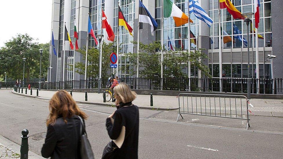 People walking past the European Parliament