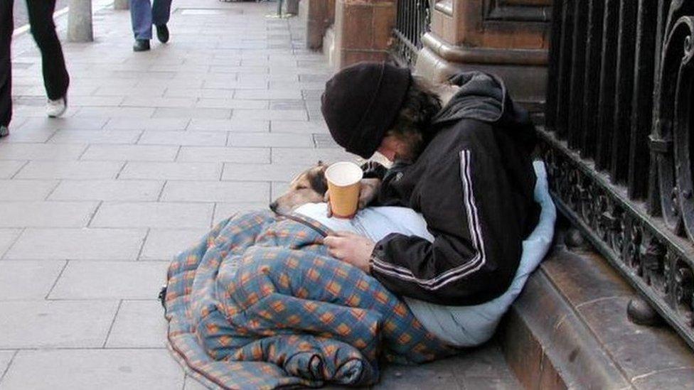 A homeless person begging