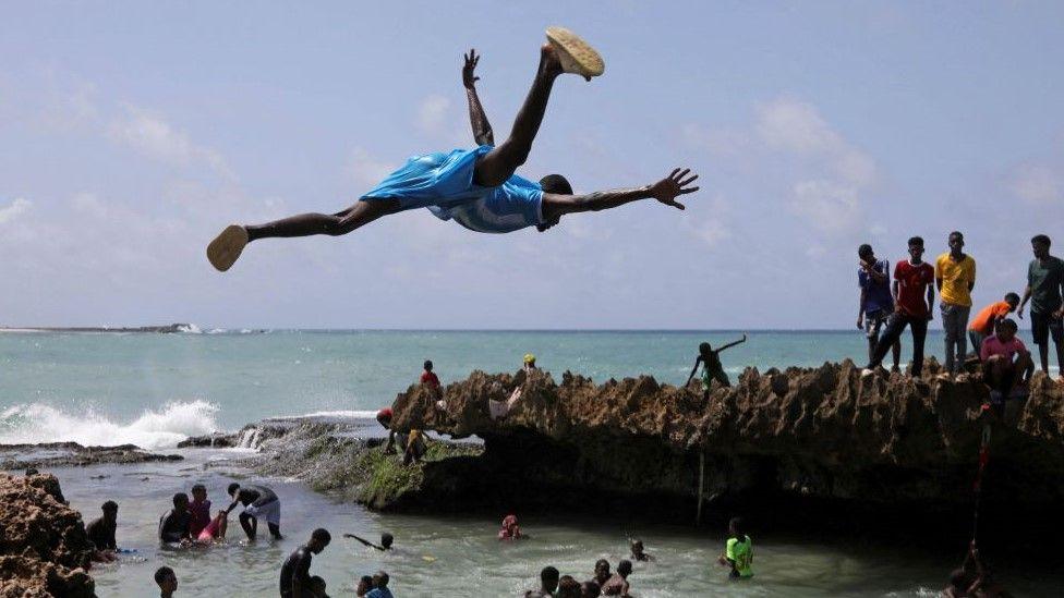 A man jumps into the Indian Ocean waters to join others in Somalia, Mogadishu on 7 June. 