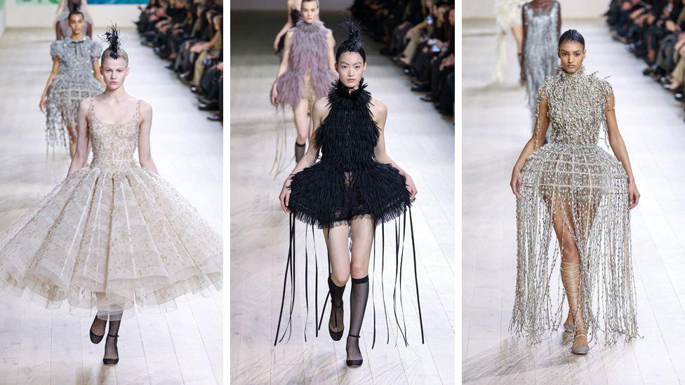 Three women appear in Dior designs, including one in a full dress with tutu skirt and two others in lampshade style dresses complete with tassels.