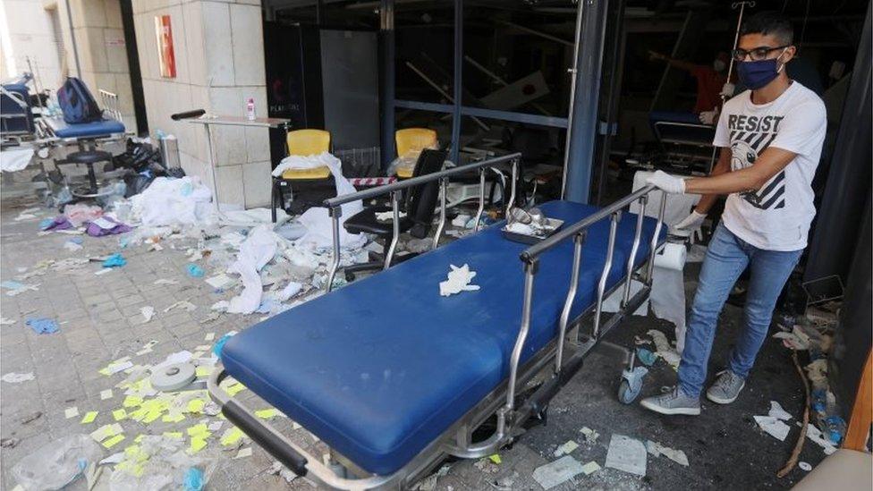 A man wearing a face mask moves a gurney at a damaged hospital following Tuesday"s blast in Beirut, Lebanon August 5, 2020.