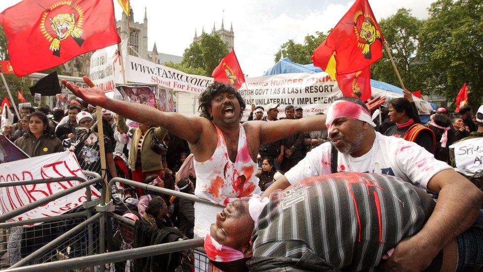 Protesters campaigning against the Sri Lankan government's offensive against the Tamil Tigers stage a mock battlefield scenario in Parliament Square on May 18, 2009 in London, England