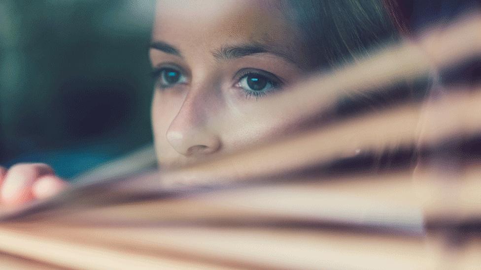 Woman looking out window