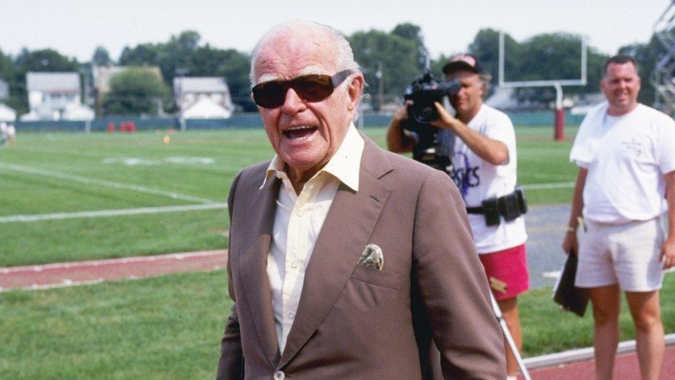 Owner Jack Kent Cooke of the Washington Redskins looks at his team during a training camp in 1994