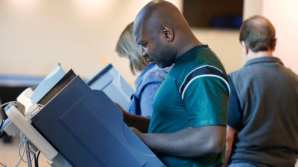 A voter casts his ballot in Utah