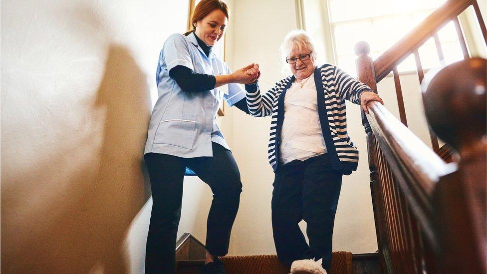 Woman being helped down stairs