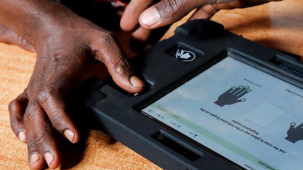 A voter uses the Kenya Integrated Election Management System (KIEMS) kit before participating in the electoral process at a polling centre by the Independent Electoral and Boundaries Commission (IEBC) in Ewaso Kedong primary school in Kajiado county, Kenya August 9, 2022