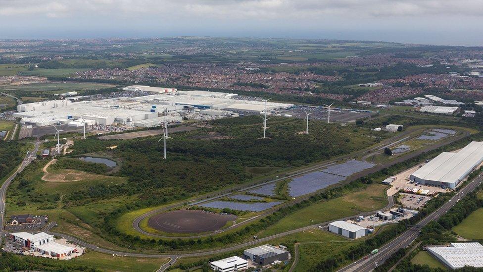 Aerial view of solar and wind farms next to Nissan