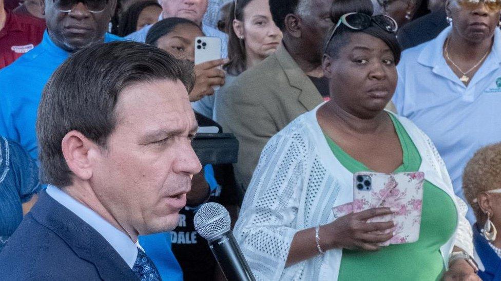 Image shows Ron DeSantis at the vigil