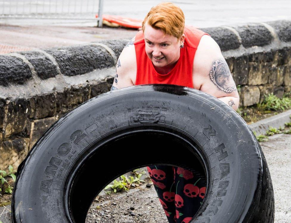 Woman flipping a tyre at One Take Fitness gym