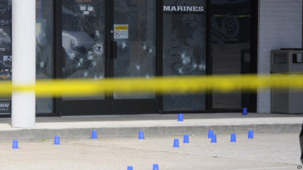 An image of the windows of the US Navy recruitment centre in Chattanooga showing several bullet holes - 16 July 2015