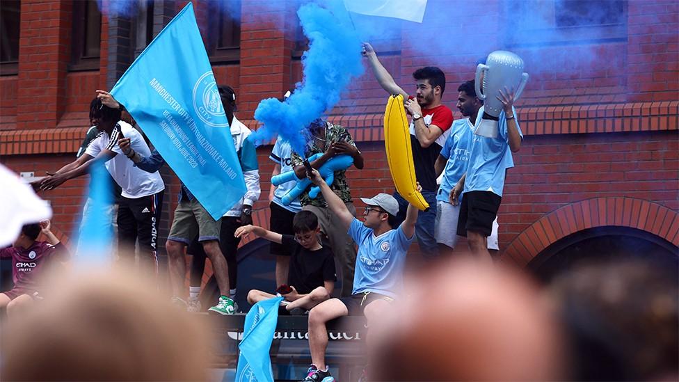 Manchester City fans let off a smoke bomb