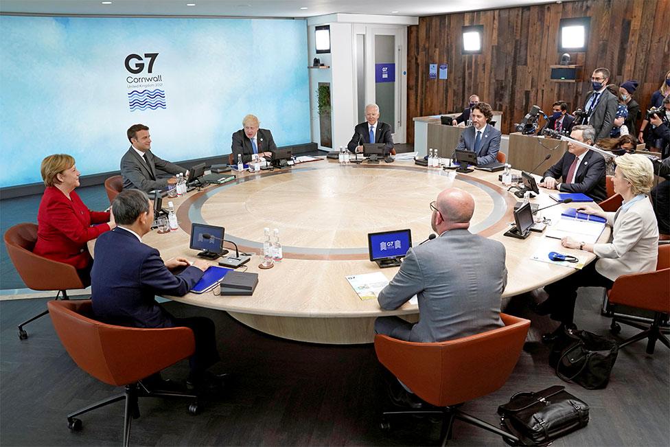 The leaders attending the G7 summit sit around a table in Cornwall