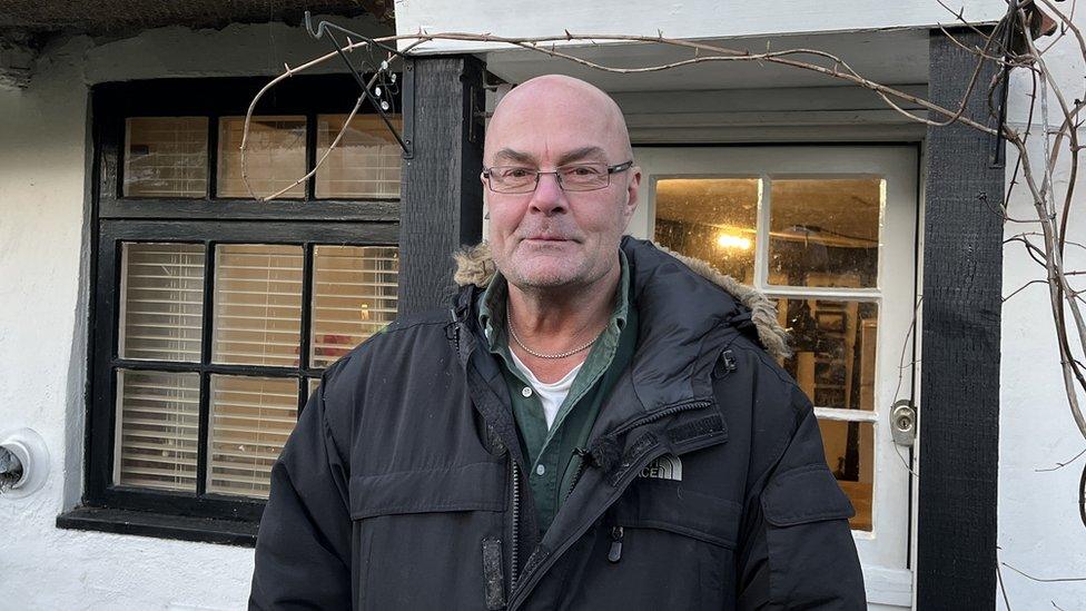 Nigel Dawson outside his home in Cambridgeshire.