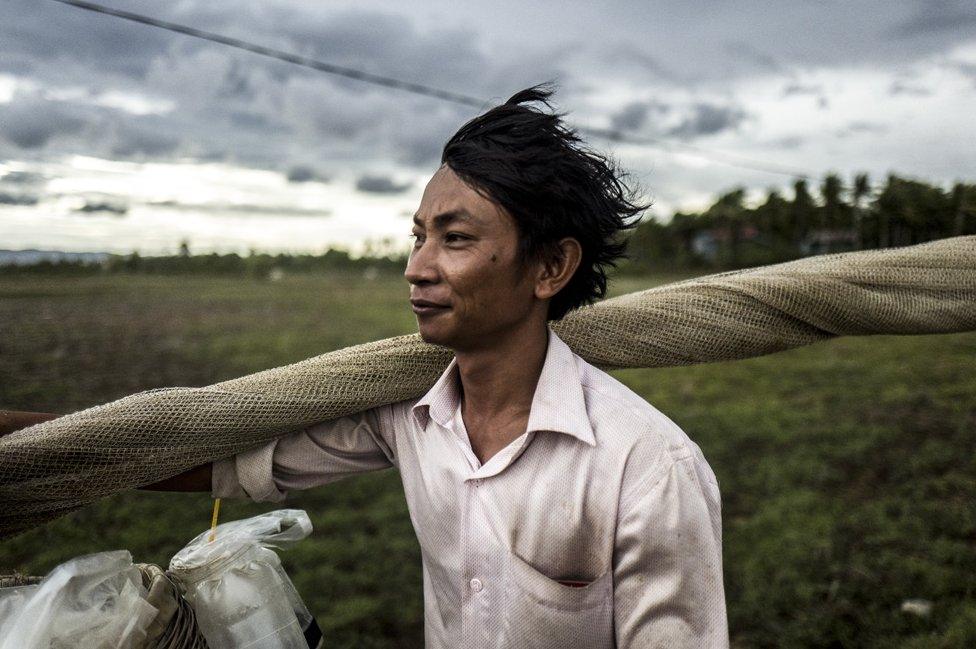 A fisherman prepares for a night fishing trip in the Trapang Sangke Community