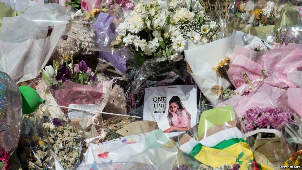 Tributes and flowers have been left in St Ann's Square in Manchester