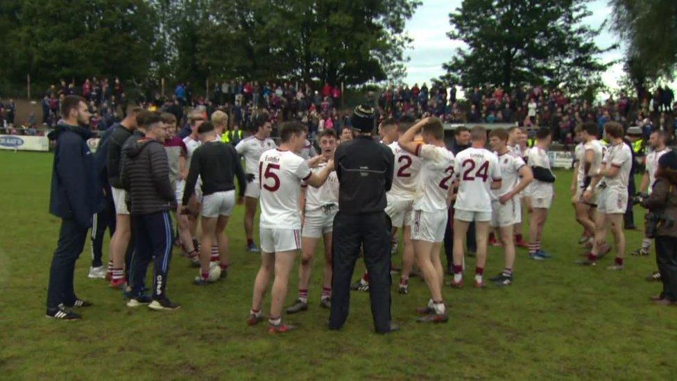 Crowds at the Derry GAA final, with the team in the foreground