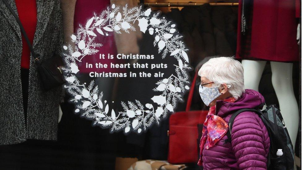 woman walking past shop window