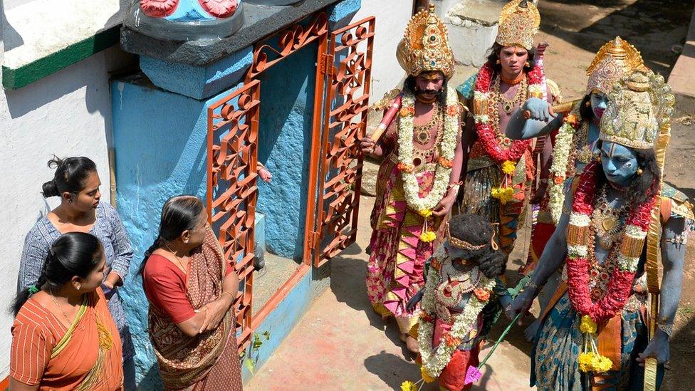 Indian men dressed as Hindu gods