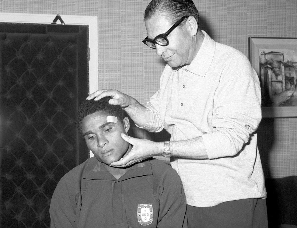 Portugal's Eusebio (left) has his injured eyebrow examined by team doctor Dr Silva Rocha during the 1966 World Cup