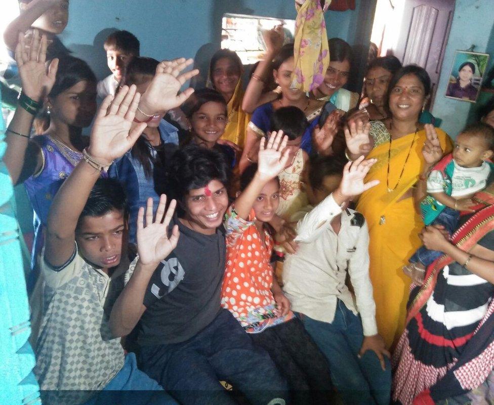 Smiling Villagers pose for a photograph with Mr Salve