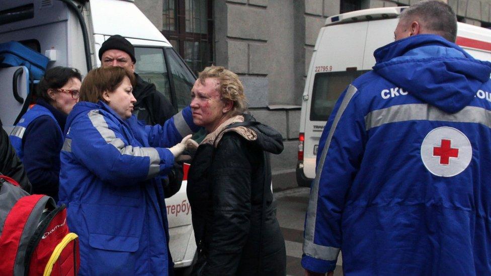 Medical personnel attend to an injured woman outside Tekhnologichesky Institut metro station in St Petersburg, Russia 3 April 2017