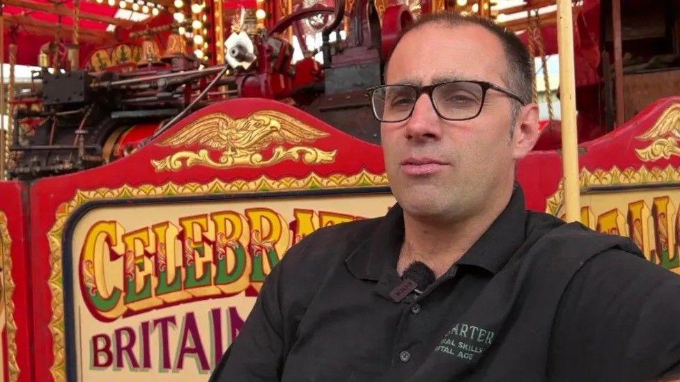 Joby Carter in front of a fair ride