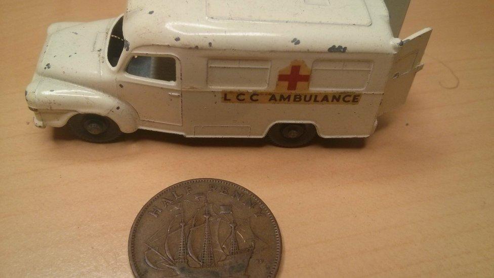 Picture of a Matchbox car and a halfpenny, representing what John buried in his time capsule