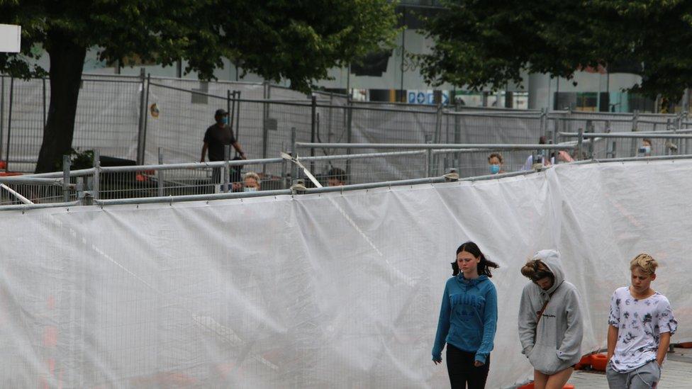 Members of the public walk within meters of those staying in enforced isolation in Christchurch, New Zealand